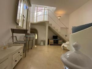 a living room with a staircase and a sink at Ca' Del Bosco in Gallipoli