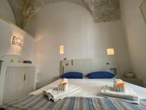 a bedroom with a bed with two towels on it at Ca' Del Bosco in Gallipoli