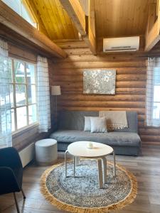 a living room with a couch and a table at Latvahonka Cottage in Jämsä