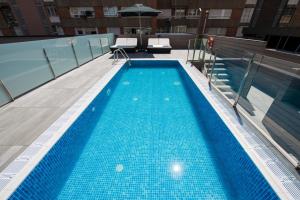 a swimming pool on the roof of a building at Catalonia Rigoletto in Barcelona