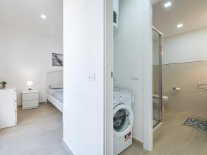 a white laundry room with a washer and dryer at Sabamiglia Apartments in Cagliari +25 photos