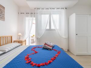 a bed with a heart made out of red roses at Sabamiglia Apartments in Cagliari