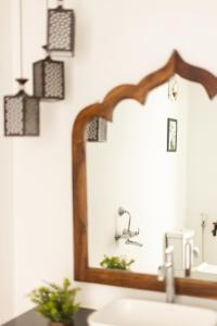 a bathroom with a mirror over a sink at The Shore beach resort Palolem in Canacona