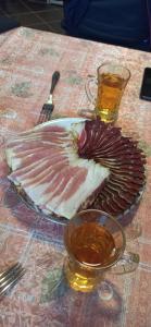 a plate with a piece of meat on a table at Porodicna brvnara Ivanovic in Zlatibor