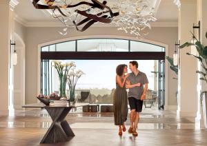 a couple standing in a living room in a house at Park Hyatt Aviara in Carlsbad