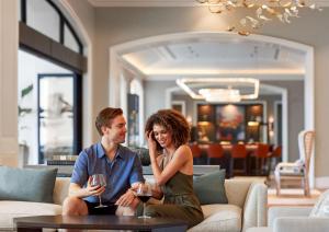 a man and a woman sitting on a couch with wine glasses at Park Hyatt Aviara in Carlsbad