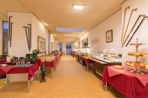 a buffet line with red clothed tables in a restaurant at Rho Hotel in Amsterdam