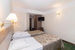 Postel nebo postele na pokoji v ubytování Hotel St. Barbara