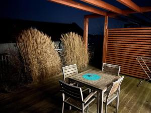 a wooden table and chairs on a patio at Palava eu 10 in Pavlov