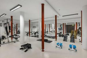 a gym with a lot of exercise equipment in it at Hotel Malmkoping; Sure Hotel Collection by Best Western in Malmköping