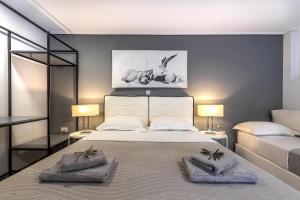 a bedroom with a large bed with two pillows on it at Comfort Stay Airport Studios - FREE shuttle from the Athens airport in Spata