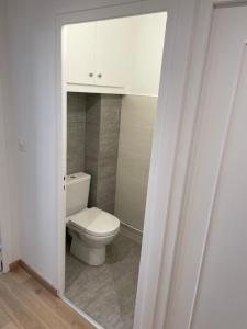 a bathroom with a toilet and a white cabinet at Vue Lac, Central et Contemporain in Évian-les-Bains