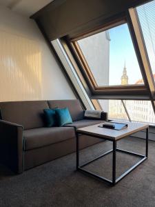a living room with a couch and a coffee table at Familienapartment mit Panoramablick zur Frauenkirche in Dresden +8 photos