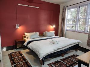 Ένα ή περισσότερα κρεβάτια σε δωμάτιο στο Shree Guest House
