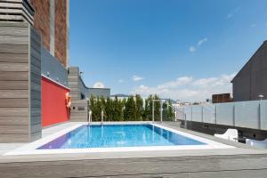 a swimming pool on the side of a building at Catalonia Roma in Barcelona