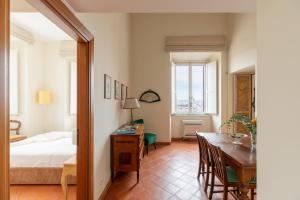 a bedroom with a bed and a table and a dining room at iFlat Spanish Steps at your Feet in Rome