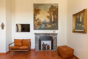 a living room with a fireplace and a painting on the wall at iFlat Spanish Steps at your Feet in Rome
