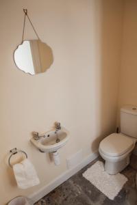 a bathroom with a sink and a toilet at Castle Cottage, a self-catering cottage full of character. in Amhuinnsuidhe