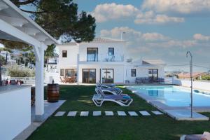 a villa with a swimming pool and a house at TESS Villa Maria in Alhaurín de la Torre