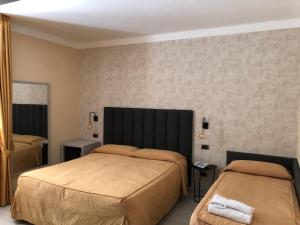 Postel nebo postele na pokoji v ubytování Hotel Tirrenia