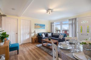 a living room with a blue couch and a table at 17 Norton Park in Dartmouth