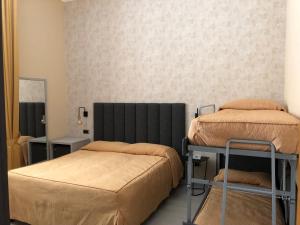 Postel nebo postele na pokoji v ubytování Hotel Tirrenia