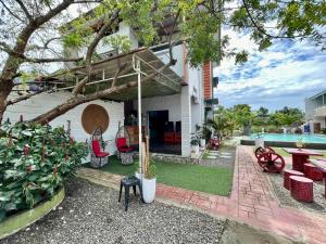 a house with a patio and a swimming pool at Little Rock Cebu in Mactan