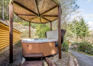 a hot tub in a wooden gazebo at Bulworthy Forest Lodges in Instow