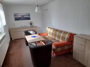 a living room with a couch and a table at Ferienwohnung Hille in Arendsee
