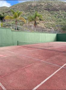 a tennis court with a net on top of it at DORY HOUSE LOS CRISTIANOS in Los Cristianos