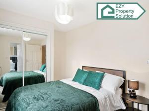 a bedroom with two beds and a mirror at Stylish 2 bed Apt - Free Parking in Thamesmead