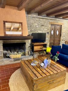 a living room with a couch and a fireplace at CAMPALANS Hotel Rural Bungalows Mobilhomes in Borredá