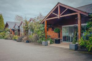 un groupe de maisons avec des plantes devant elles dans l'établissement Draycote Hotel And Whitefields Golf Course, à Rugby