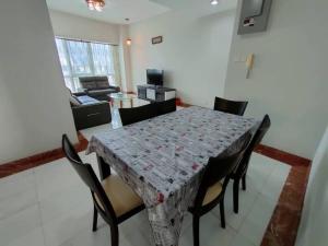 a dining room with a table and chairs at Kuching City 3Bedrooms Apartment in Kuching