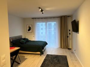 Telewizja i/lub zestaw kina domowego w obiekcie Harmonia Apartments