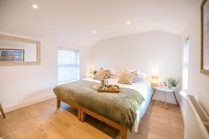 a bedroom with a bed with a table on it at The Old Shop in Leiston