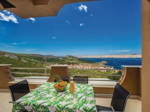 a dining room with a table and a view of the water at Apartments Villa Kim in Jablanac