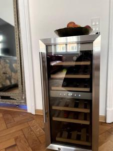 an open refrigerator with wine bottles inside of it at Penthouse Wohnung in 1A City-Lage in Bamberg in Bamberg