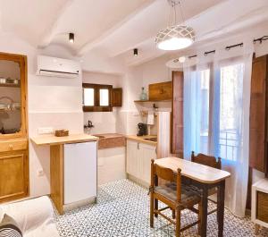 a kitchen with a wooden table and a table and chairs at Ca tia Teresa in Planes +20 photos