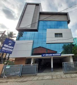 a building with a star services sign in front of it at Sharp Suites in Ernakulam