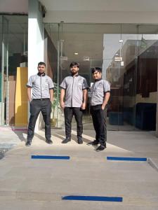 a group of three men standing in front of a building at ذوق الخيال للشقق المخدومة Dhoq Alkhayal in Al Ahsa