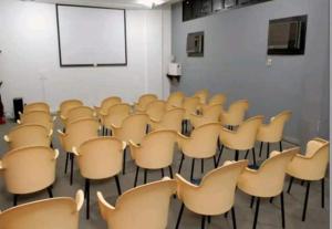 an empty room with chairs and a white wall at AP Alecrim Porto Real Suítes com Tela de Proteção Praia Privativa in Mangaratiba +132 photos