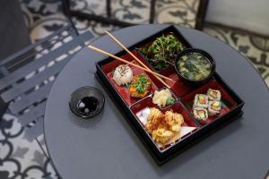 a tray of food on a table with sushi at The Tophams Hotel in London