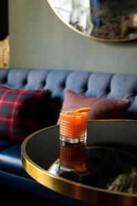 a drink sitting on a table on a table at The Tophams Hotel in London