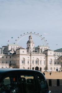 a car parked in front of a building with a ferris wheel at The Tophams Hotel in London