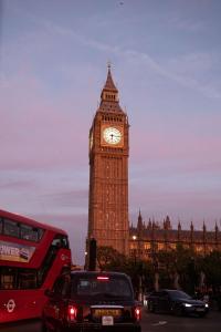 a clock tower in london with big ben in the background at The Tophams Hotel in London