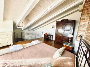 a bedroom with two beds in a attic at Relais Palazzo Paleologi Sec.XIV in Lu