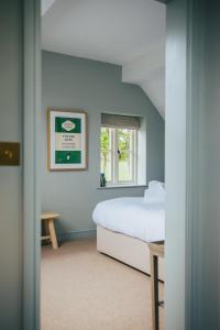 a bedroom with a bed and a window at The Bottle & Glass Inn in Harpsden