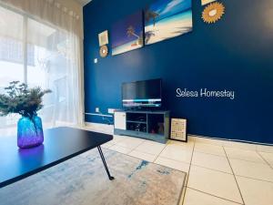 a living room with a tv on a blue wall at OCEAN ESCAPE@Selesa Hillhomes, Bukit Tinggi Pahang in Bentong