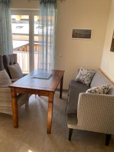 a living room with a table and a couch at Ferienhaus Ute in Weissbriach
